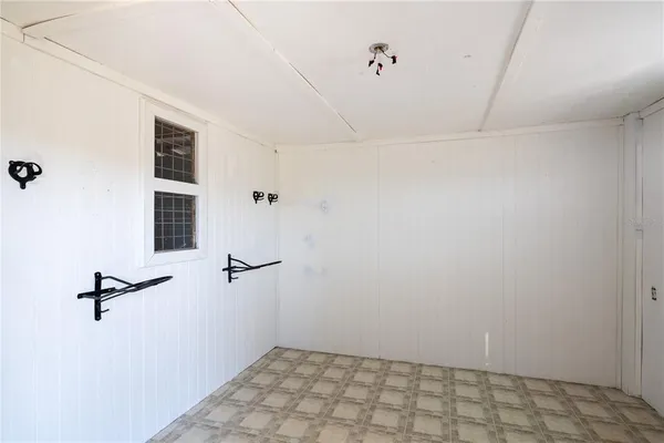 an empty room with a window and wooden floor