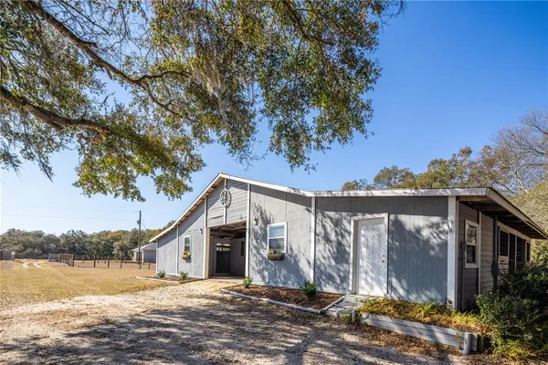 a bathroom with a granite countertop sink a toilet and a shower