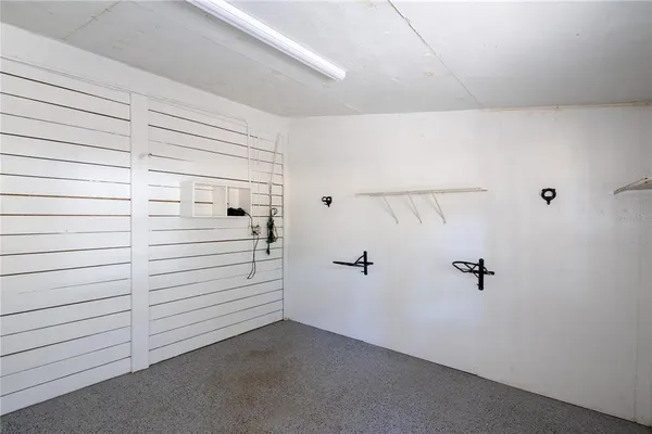 a kitchen that has a refrigerator a stove and a sink with wooden floor
