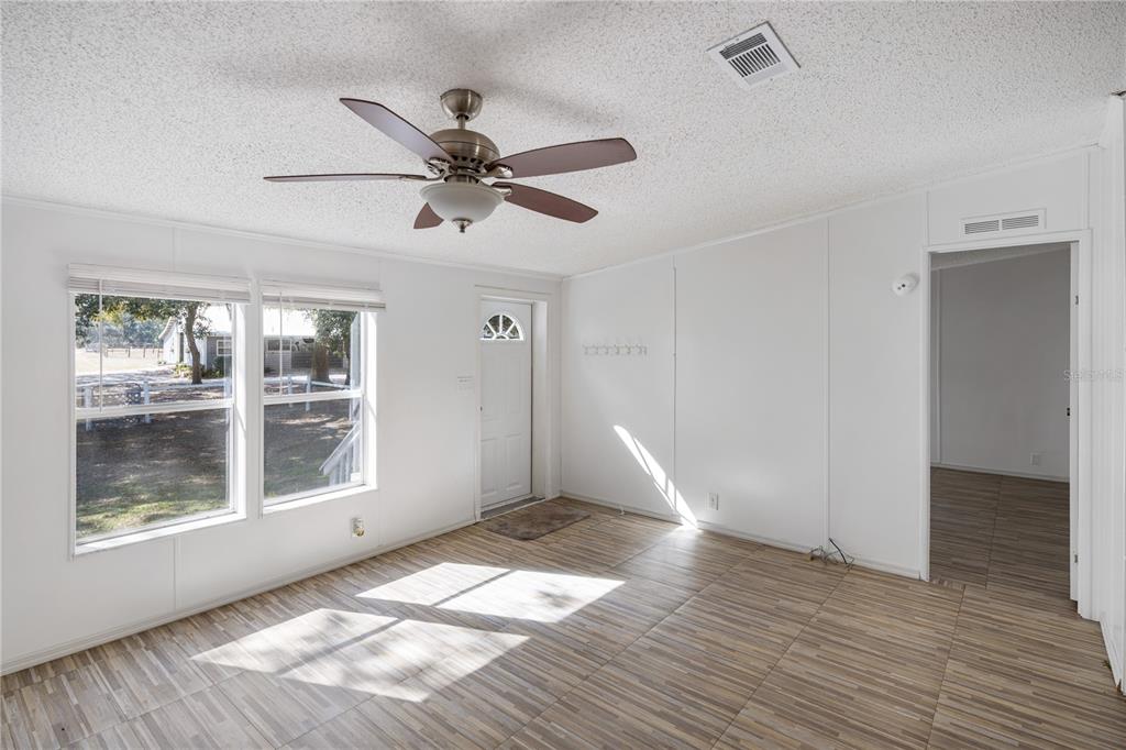 4495 Southeast 150th Street Summerfield, FL 34491 - Photo 59 of 76 a view of empty room with wooden floor and fan