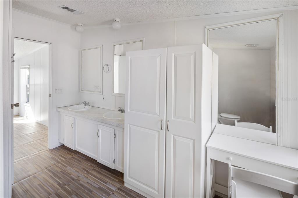 4495 Southeast 150th Street Summerfield, FL 34491 - Photo 64 of 76 a bathroom with a granite countertop sink a toilet and a shower