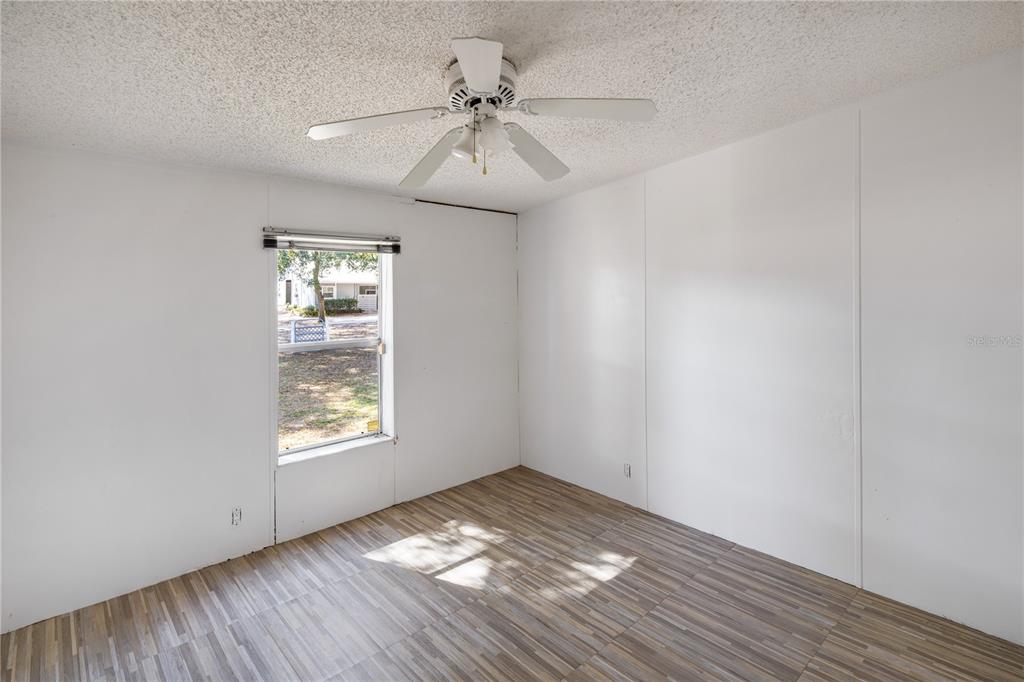 4495 Southeast 150th Street Summerfield, FL 34491 - Photo 67 of 76 an empty room with a window and wooden floor