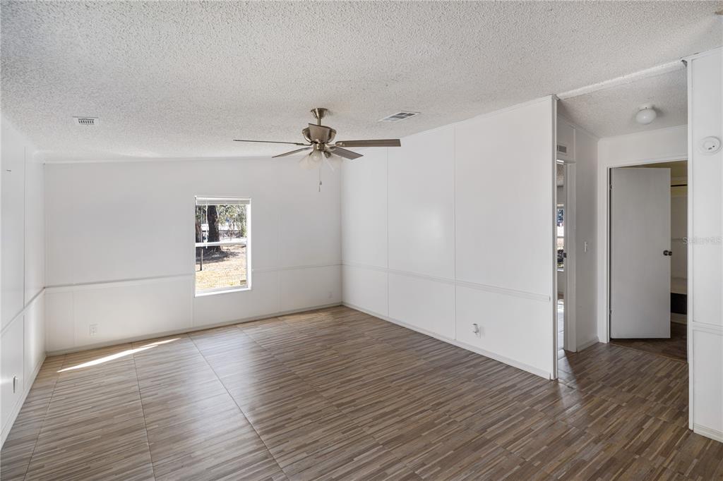4495 Southeast 150th Street Summerfield, FL 34491 - Photo 69 of 76 a view of a room with wooden floor and white walls