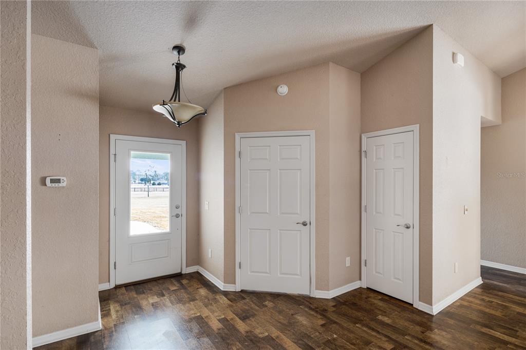 4495 Southeast 150th Street Summerfield, FL 34491 - Photo 7 of 76 a view of an empty room with wooden floor