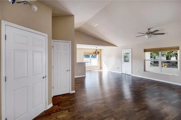 a view of a kitchen with a sink wooden cabinets and a window