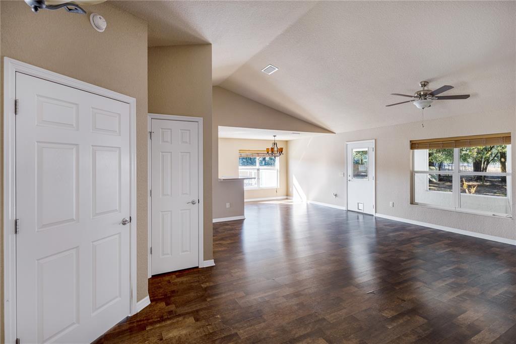 4495 Southeast 150th Street Summerfield, FL 34491 - Photo 9 of 76 wooden floor in an empty room with a window