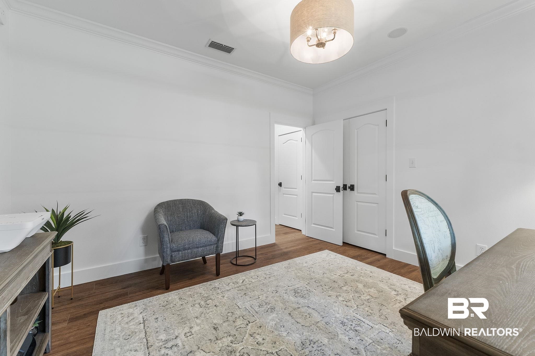 4451 Millhouse Road Gulf Shores, AL 36542 - Photo 25 of 50 Home office with crown molding and hardwood / wood-style floors