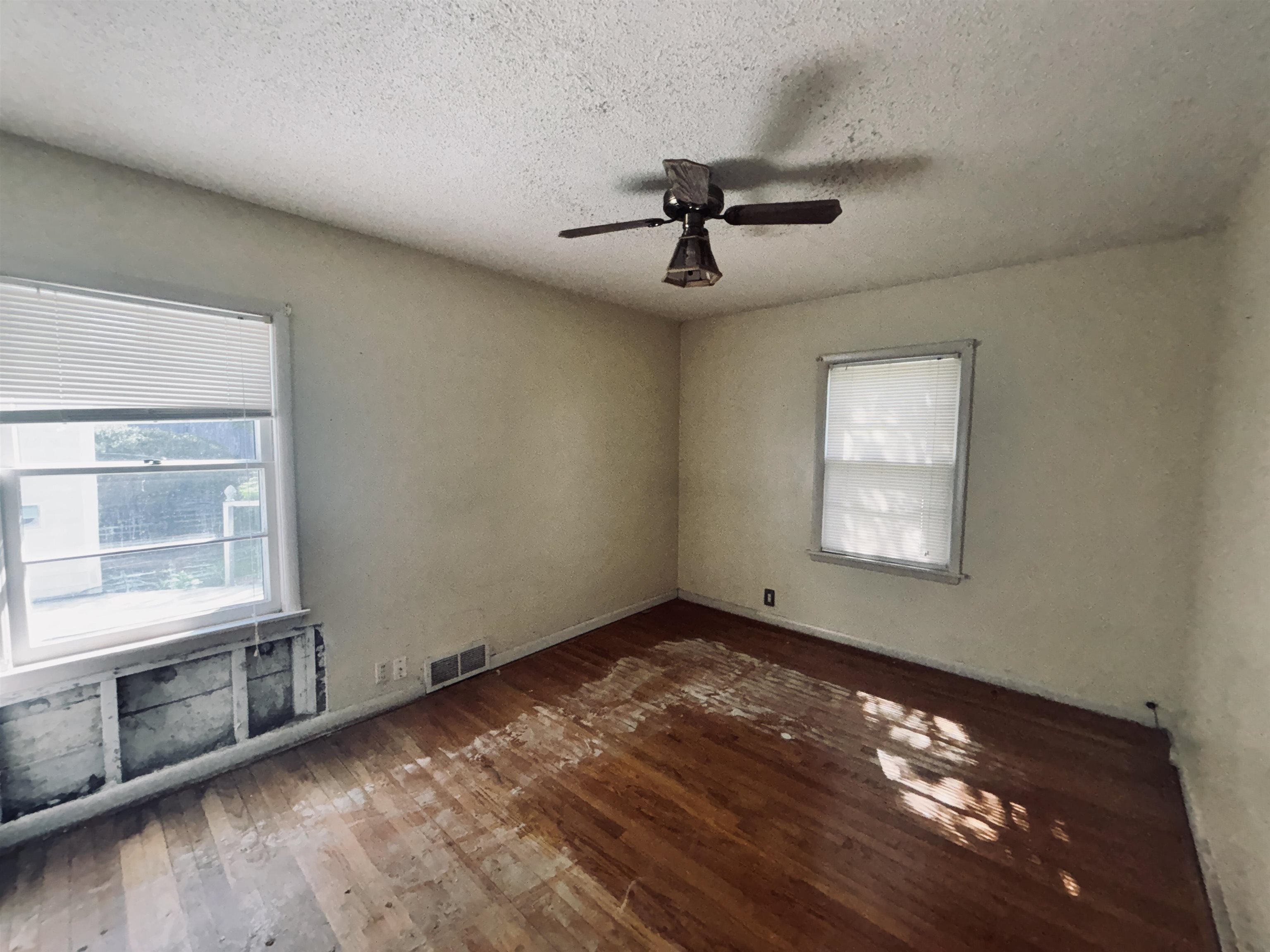 1331 West Logan Street Freeport, IL 61032 - Photo 11 of 30 a view of empty room with wooden floor and fan