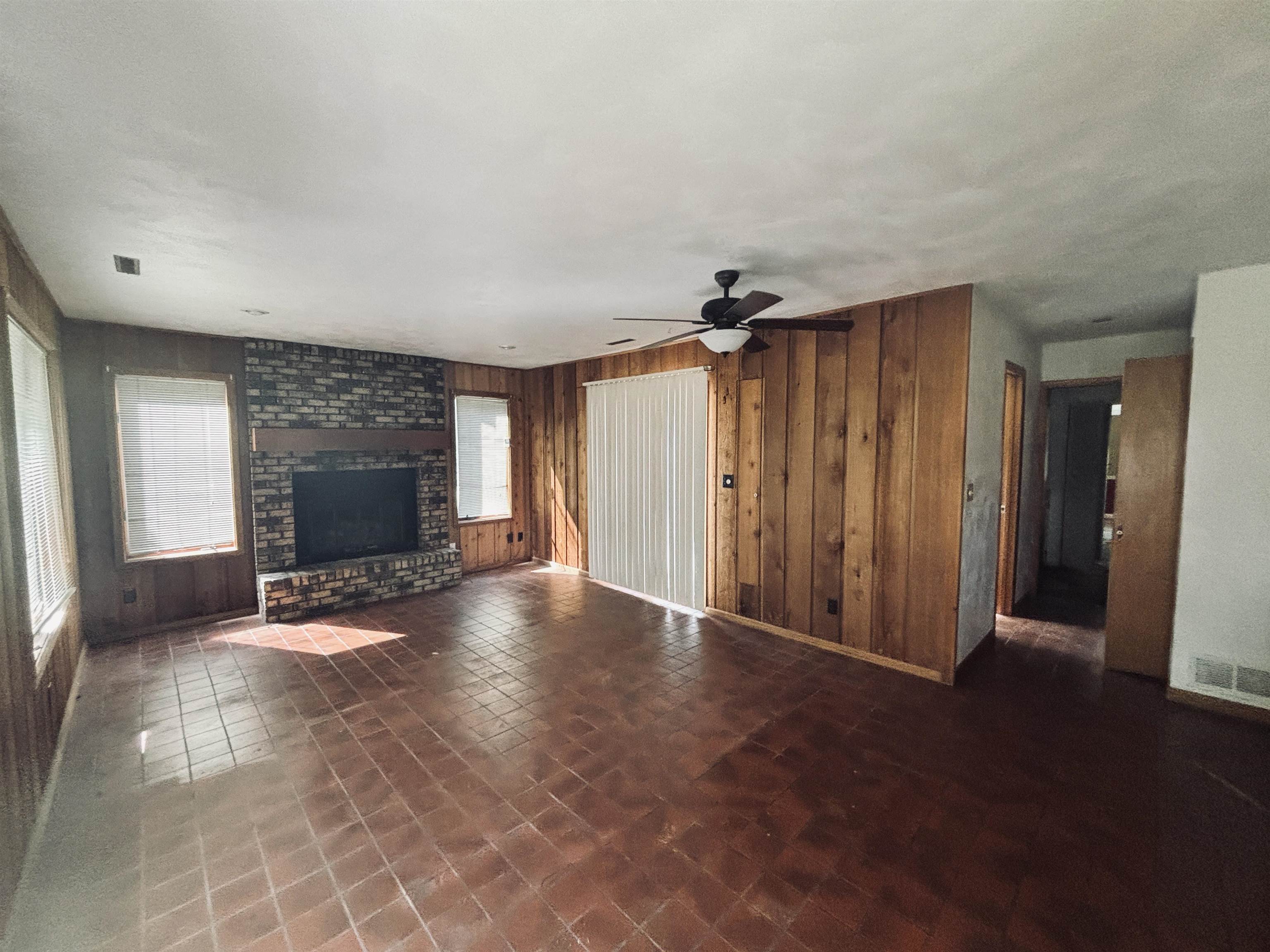 1331 West Logan Street Freeport, IL 61032 - Photo 2 of 30 an empty room with windows and fireplace