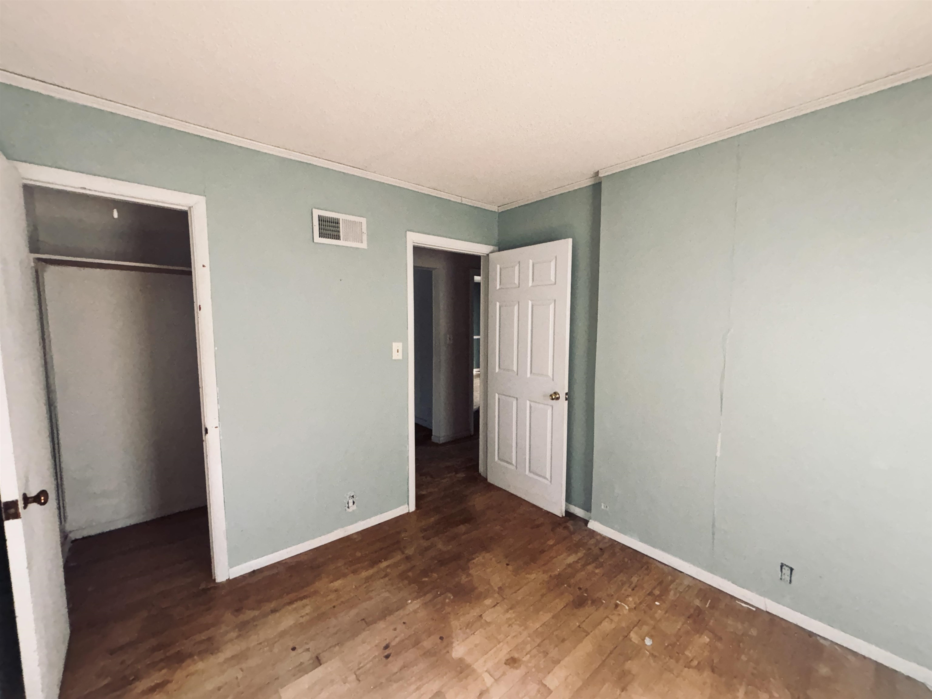 1331 West Logan Street Freeport, IL 61032 - Photo 21 of 30 a view of an empty room with wooden floor and a window