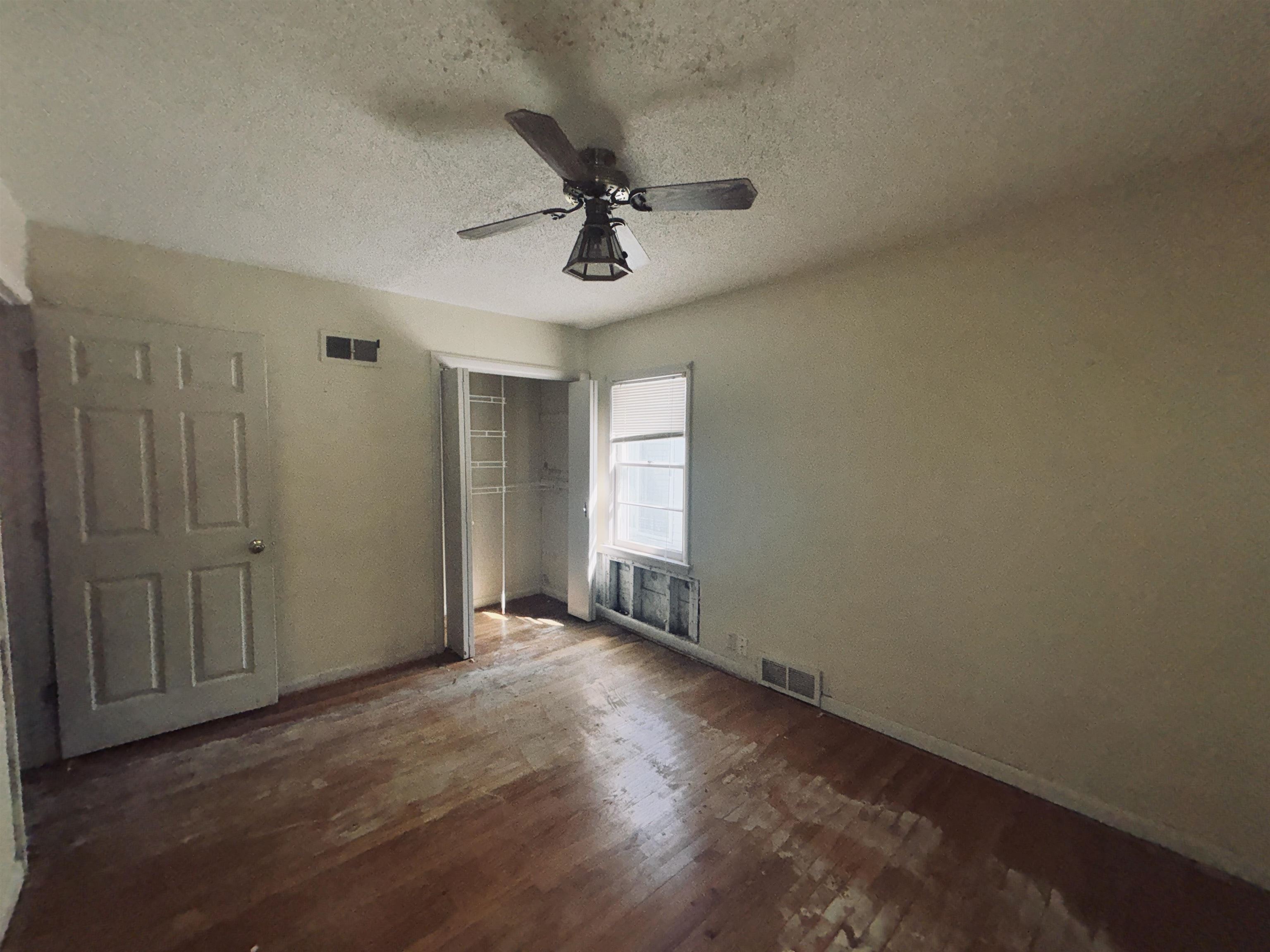 1331 West Logan Street Freeport, IL 61032 - Photo 26 of 30 an empty room with wooden floor fan and windows