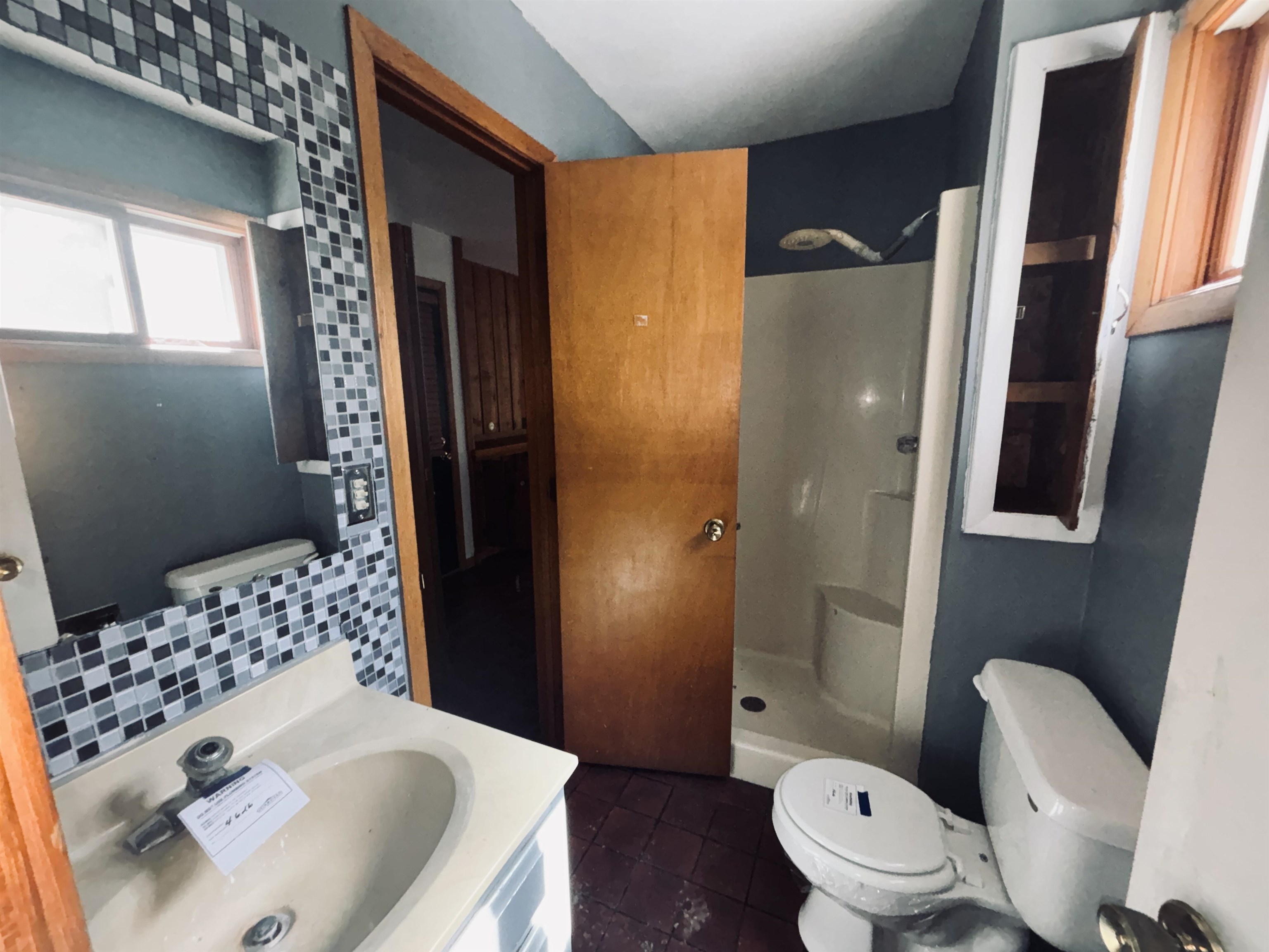 1331 West Logan Street Freeport, IL 61032 - Photo 29 of 30 a bathroom with a sink toilet and shower