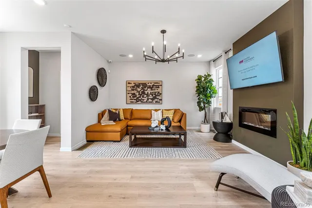 a room with a large window and chandelier