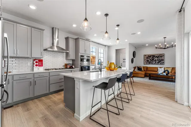 a view of staircase with wooden floor and a chandelier