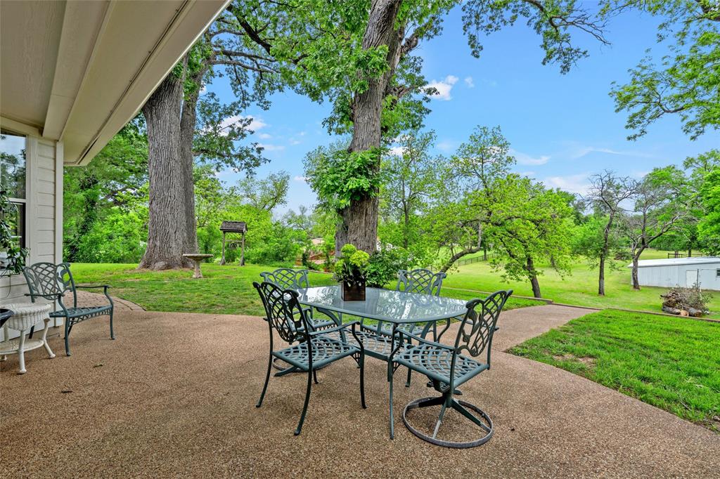 743 Stillwater Road Waco, TX 76708 - Photo 32 of 40 a view of a backyard with table and chairs with a yard and plants
