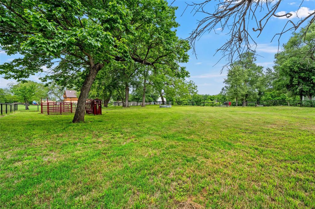 743 Stillwater Road Waco, TX 76708 - Photo 35 of 40 a view of a grassy field with trees in the background