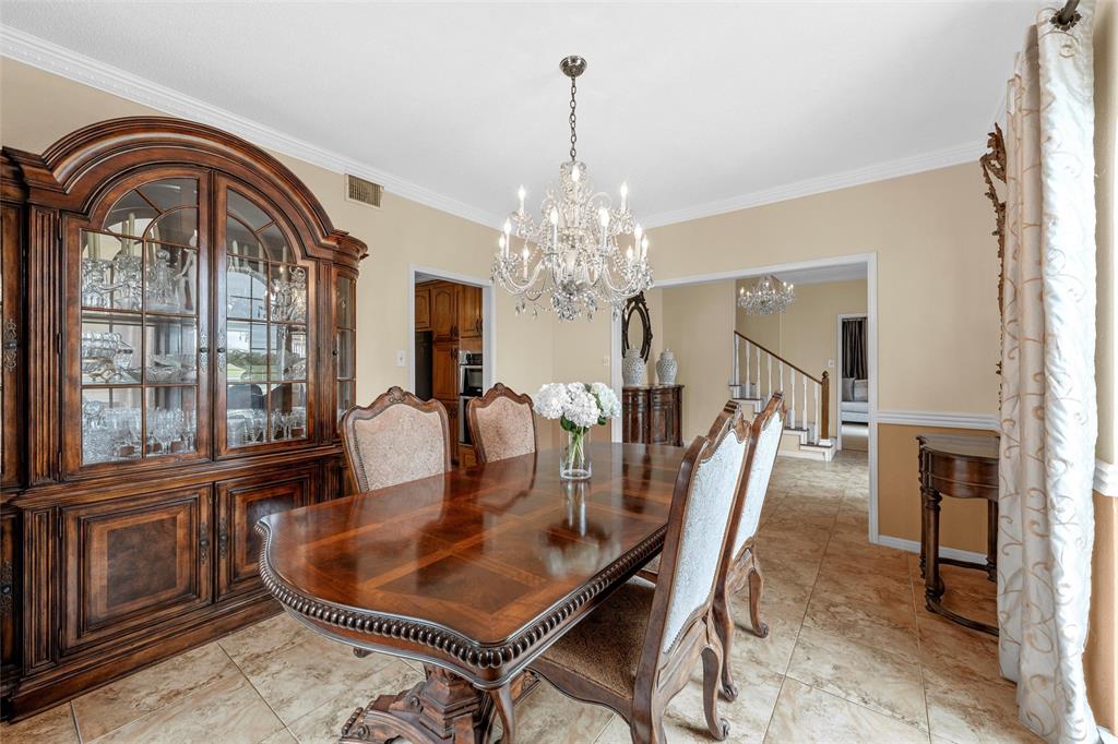743 Stillwater Road Waco, TX 76708 - Photo 8 of 40 a dining room with furniture a chandelier and fireplace