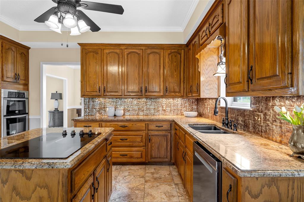 743 Stillwater Road Waco, TX 76708 - Photo 10 of 40 a kitchen with stainless steel appliances granite countertop a sink a stove and a microwave oven