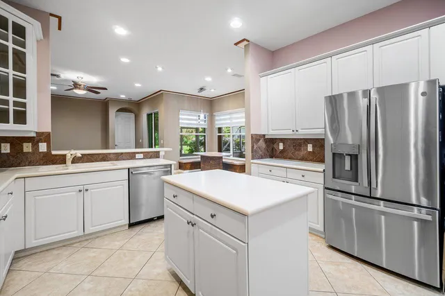 an aerial view of residential houses with outdoor space and trees all around