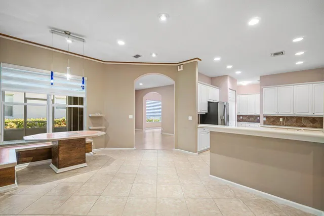 an aerial view of residential houses with outdoor space and trees all around