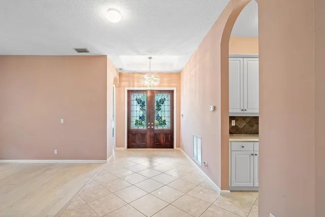 a kitchen with a sink a stove top oven and white cabinets