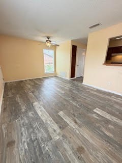 6702 Everhart Road, Unit A107 Corpus Christi, TX 78413 - Photo 3 of 13 a view of a livingroom with wooden floor and cabinet