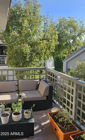 a view of a patio with couches table and chairs and potted plants