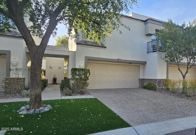 a view of a house with backyard and a tree