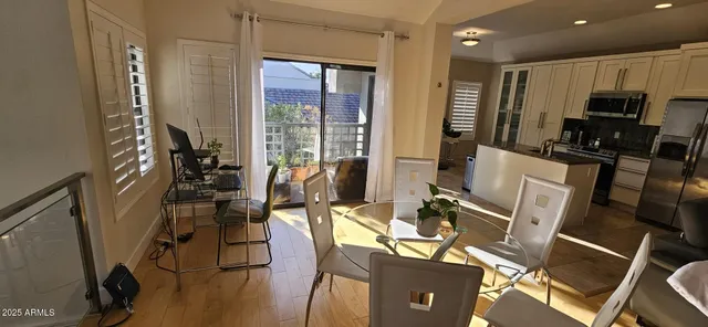 a view of a dining room with furniture window and wooden floor