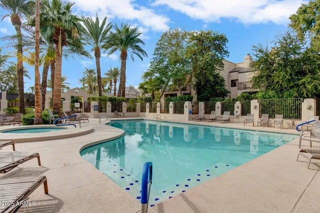 a view of swimming pool with a table and chairs