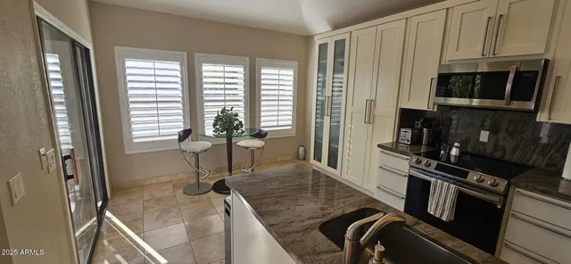 a kitchen with a sink appliances and cabinets
