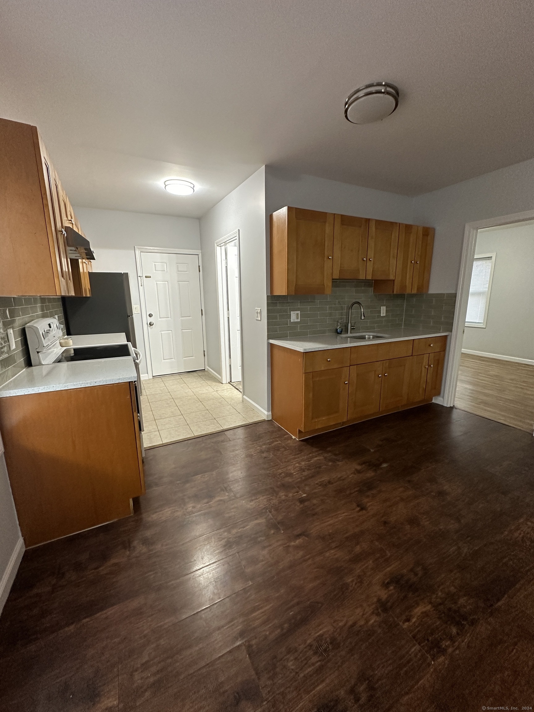 49 Howard Street Waterbury, CT 06705 - Photo 3 of 8 a view of a room with wooden floor