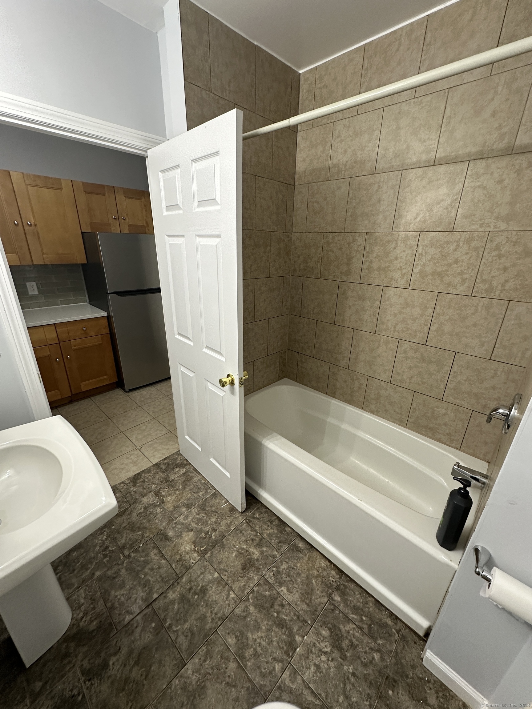 49 Howard Street Waterbury, CT 06705 - Photo 4 of 8 a bathroom with a bathtub and a toilet