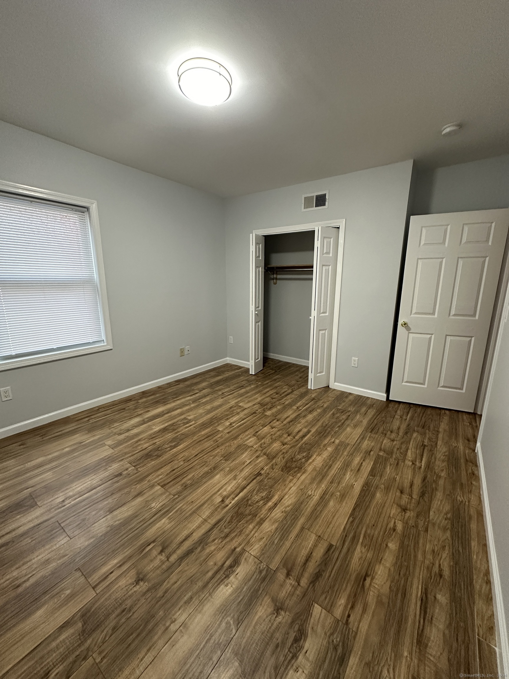 49 Howard Street Waterbury, CT 06705 - Photo 5 of 8 a view of an empty room and wooden floor