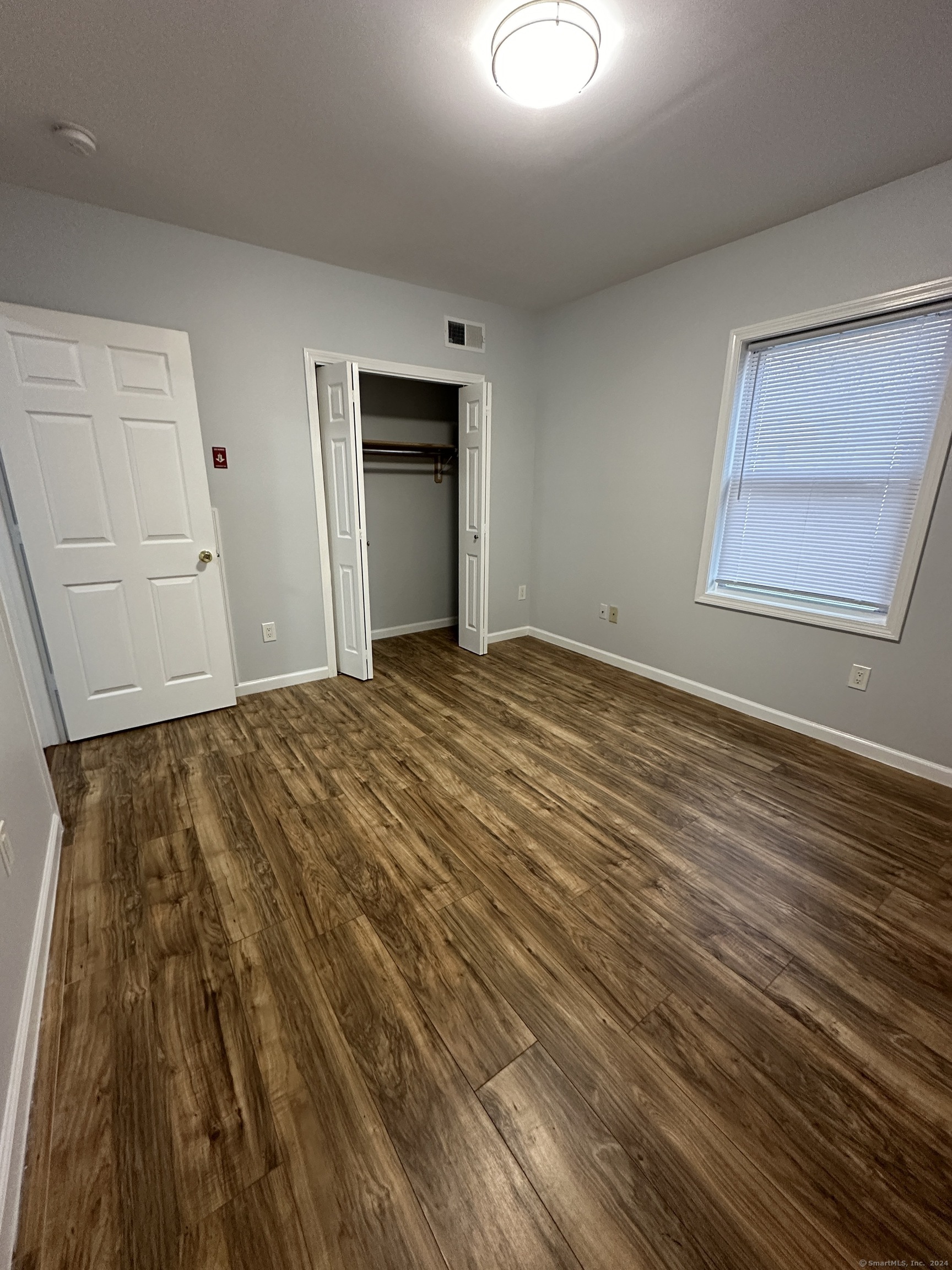 49 Howard Street Waterbury, CT 06705 - Photo 7 of 8 a view of empty room with wooden floor