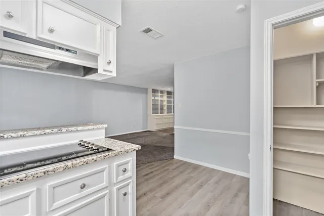 a stove top oven sitting inside of a kitchen