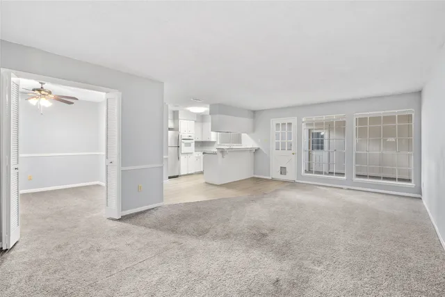 a view of a big room with closet and windows