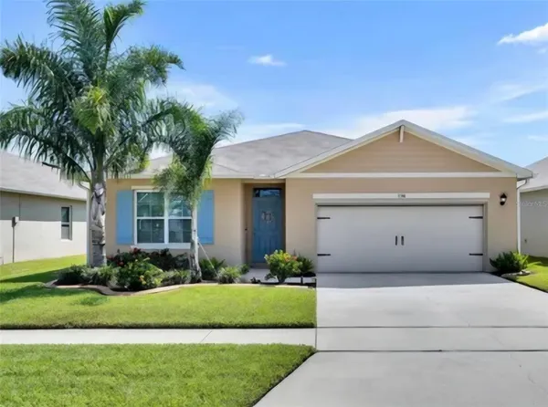 a front view of a house with a garden and plants
