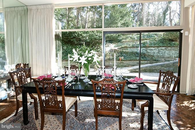 a view of a dining room with furniture and window in the patio