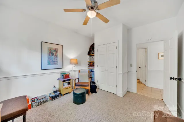 a kitchen with white cabinets and sink