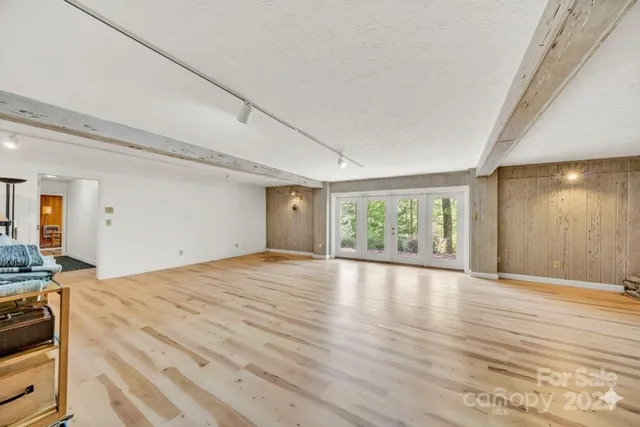 a living room with furniture a table and a large window