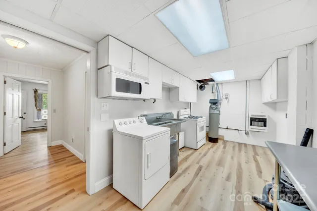 a kitchen with a stove and white cabinets