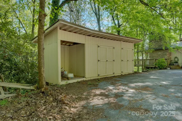 a view of a house with a big yard and large trees