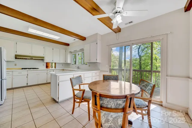 a very nice looking open kitchen with stainless steel appliances kitchen island granite countertop a sink and cabinets