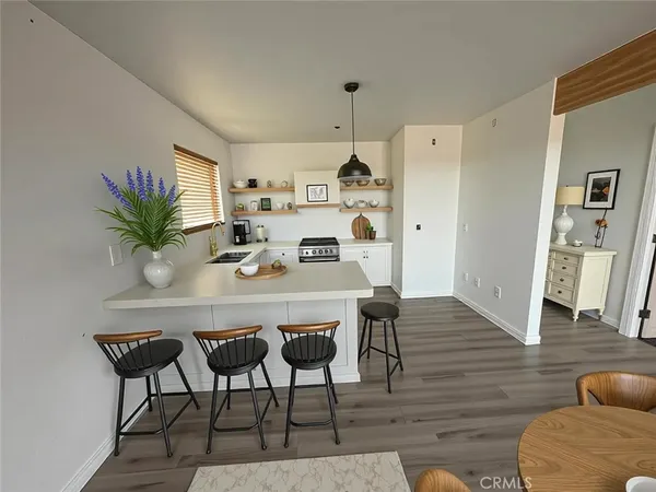 a dining room with furniture and wooden floor