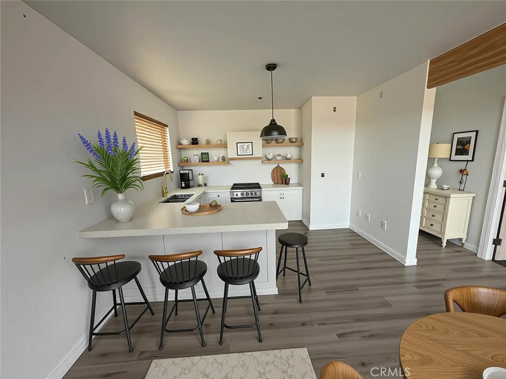 a dining room with furniture and wooden floor