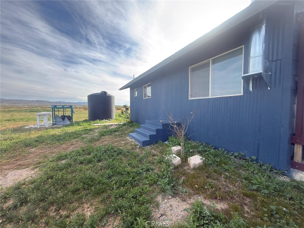 1320 Jacks Ranch Road Ridgecrest, CA 93555 - Photo 15 of 18 a backyard of a house with table and chairs