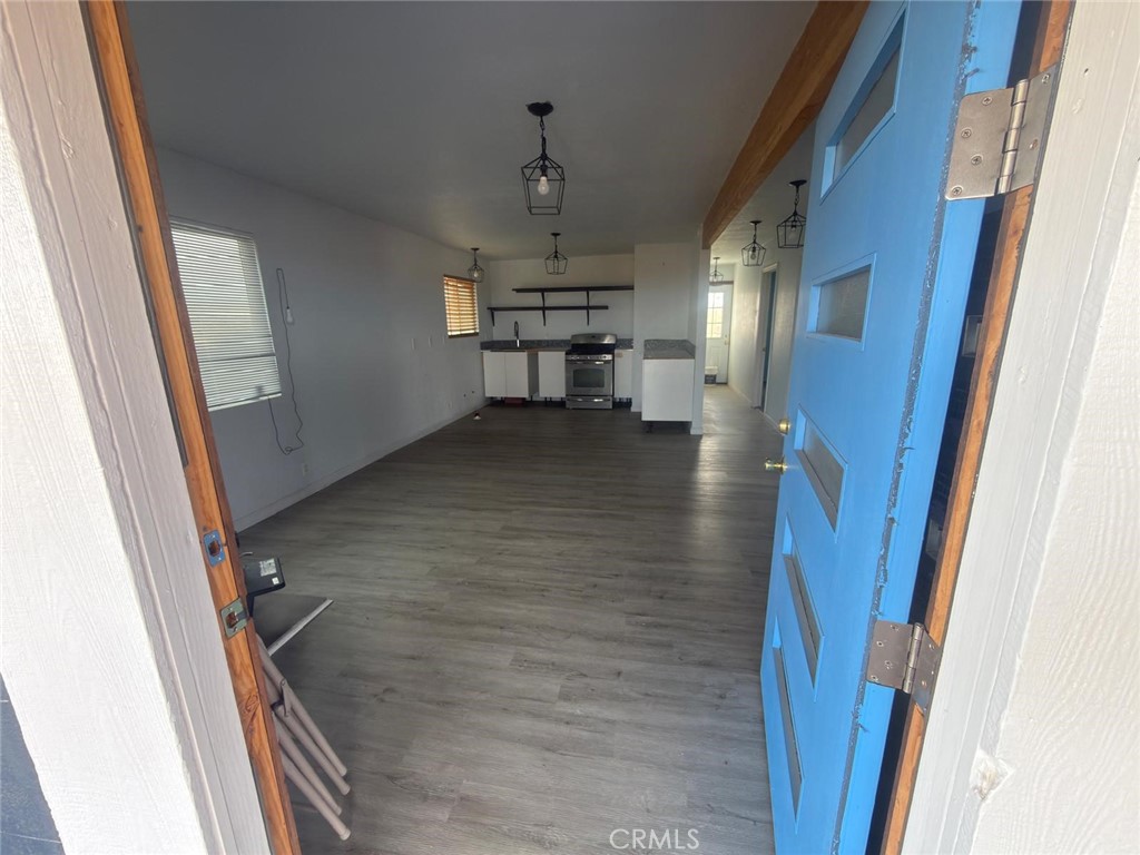 1320 Jacks Ranch Road Ridgecrest, CA 93555 - Photo 2 of 18 a view of a hallway to a livingroom and a kitchen with furniture
