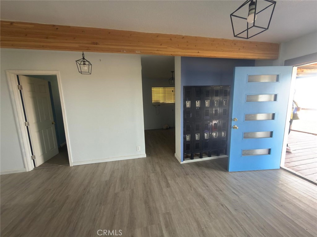 1320 Jacks Ranch Road Ridgecrest, CA 93555 - Photo 5 of 18 a view of a hallway with wooden floor and closet