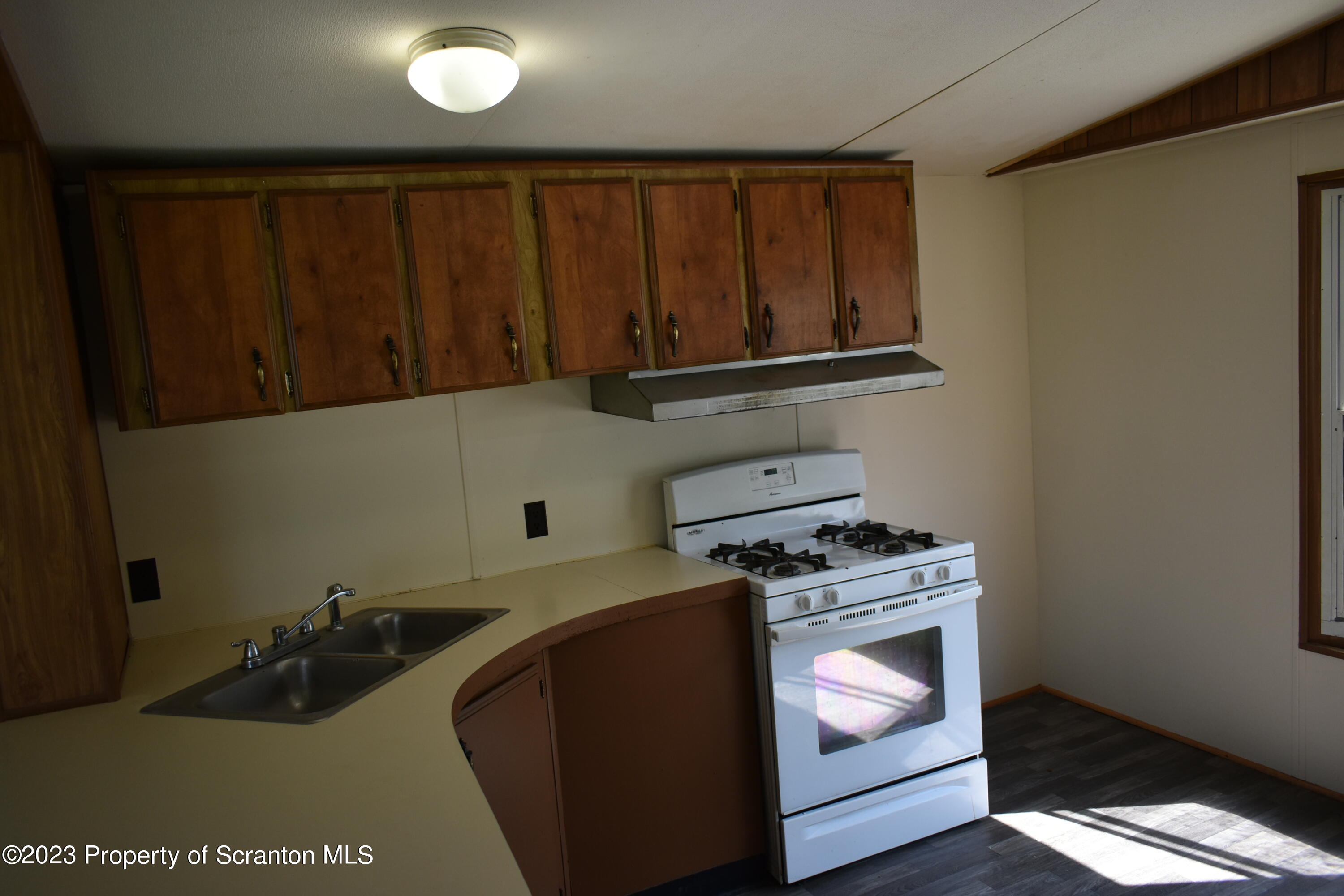 940 Nowlan Road, Unit 6 Port Crane, NY 13833 - Photo 4 of 11 a kitchen with wooden cabinets and a stove top oven